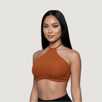 Woman wearing a brown ribbed halter top against a plain background